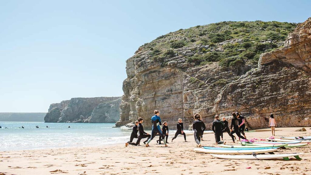 good-feeling-surf-school-group-stretching-beach